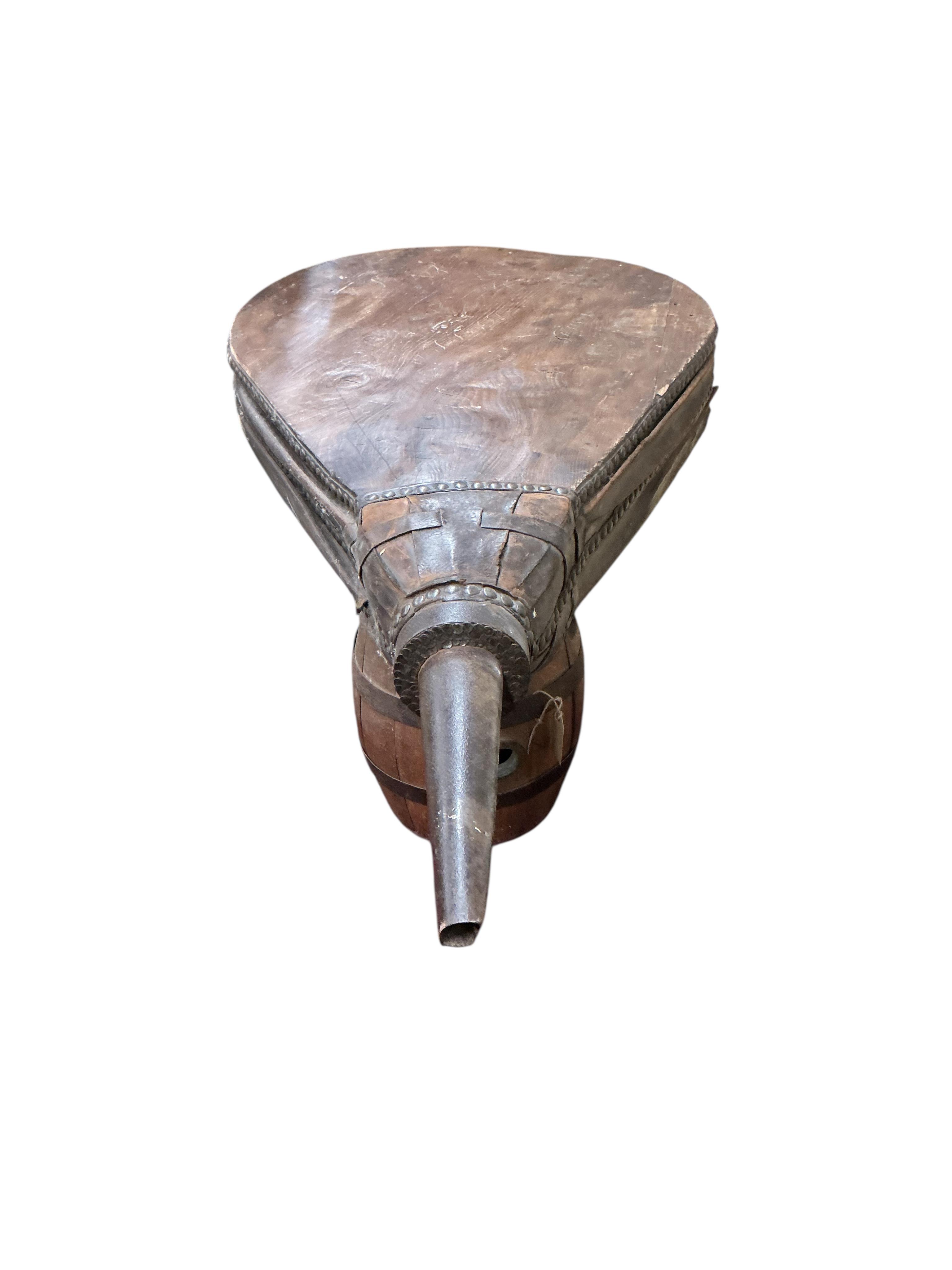 A set of 19th century iron and leather mounted oak blacksmith's bellows, now as a coffee table on twin barrel supports, width 63cm, depth 80cm, height 59cm